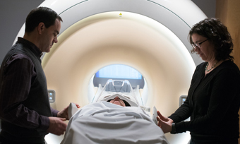 Physicians readying a patient for an MRI