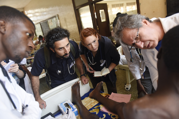 Doctors and medical students examine a patient at Mulago Hospital in Kampala, Uganda.