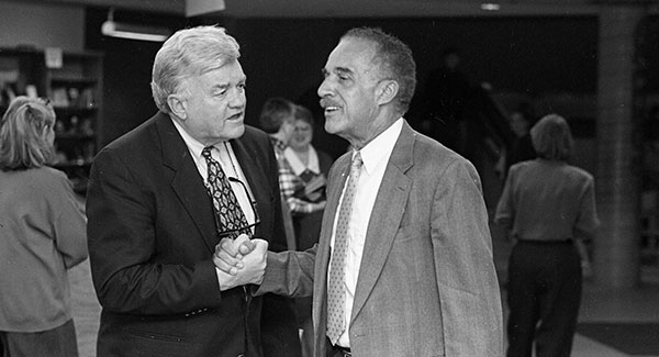 Dr. McCrorey (right) shakes hands with former Vermont Governor Thomas Salmon, who served as UVM’s president from 1993-1998, at the opening of the McCrorey Gallery in 1995.