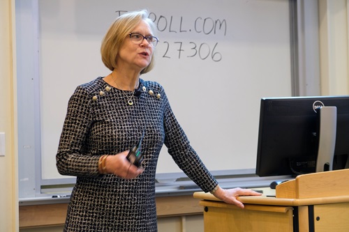 woman standing at lectern speaking