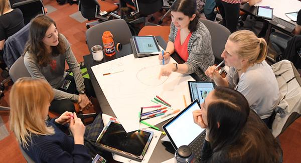 Members of the Larner medical student Class of 2022 gather in small groups in the Reardon Classroom during the Nutrition, Metabolism and Gastrointestinal Systems course