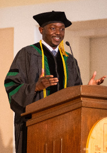 Mtuke Standing at Podium