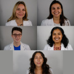 Five medial students smiling wearing white coats