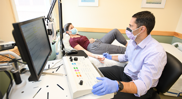 Noah Kolb Dr. Kolb (at right) with a patient in an exam room.