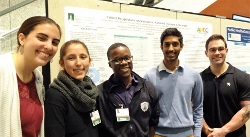 Group of medical students in front of their public health project poster